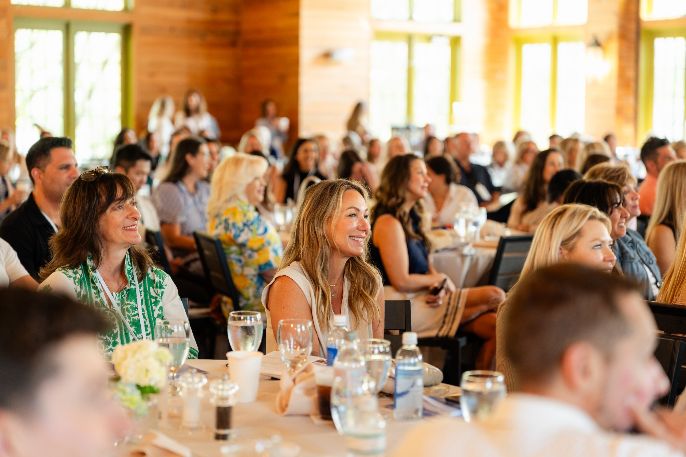 Attendees smiling during the summit