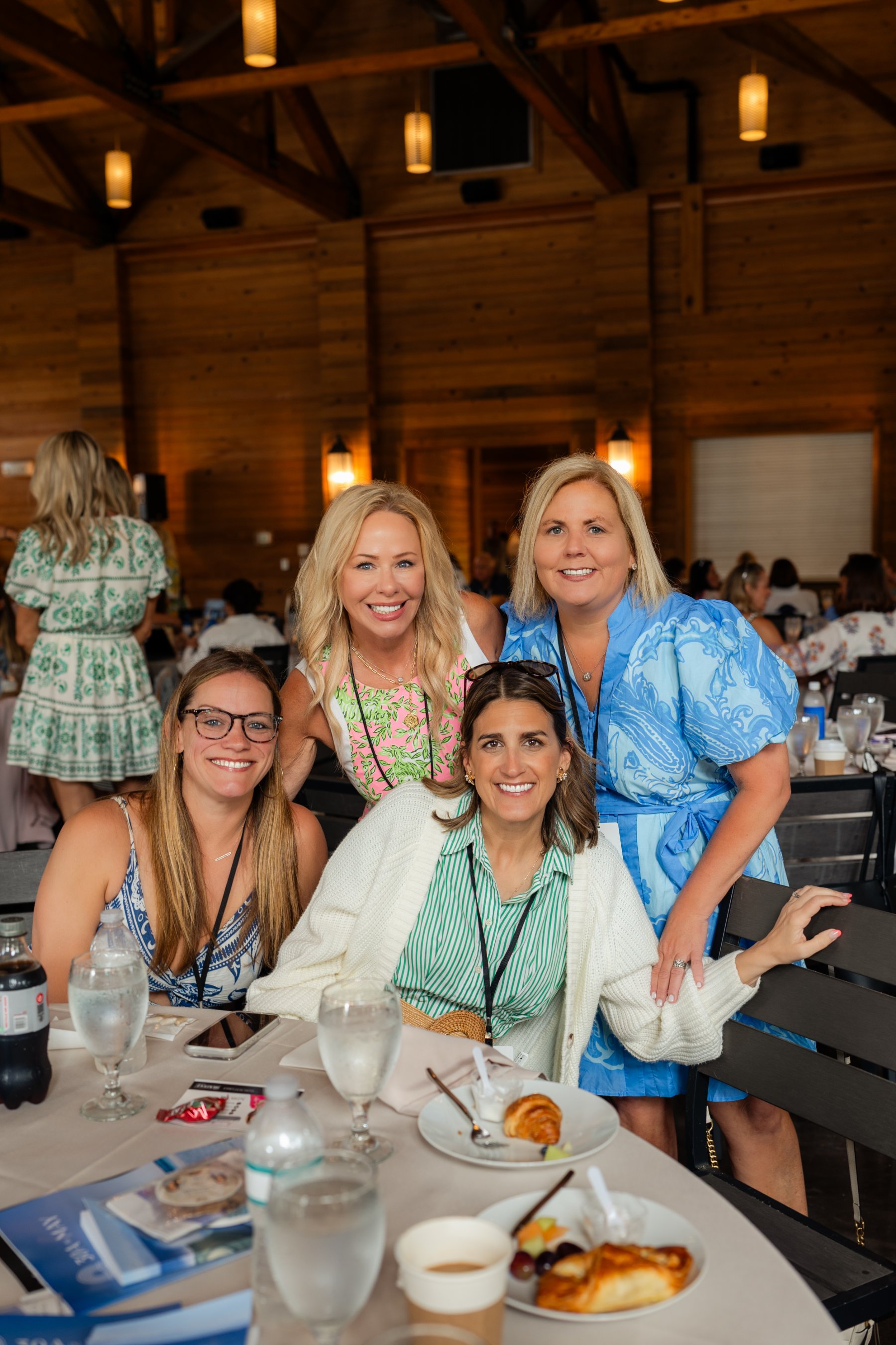 Four agents posing together at their table during the summit