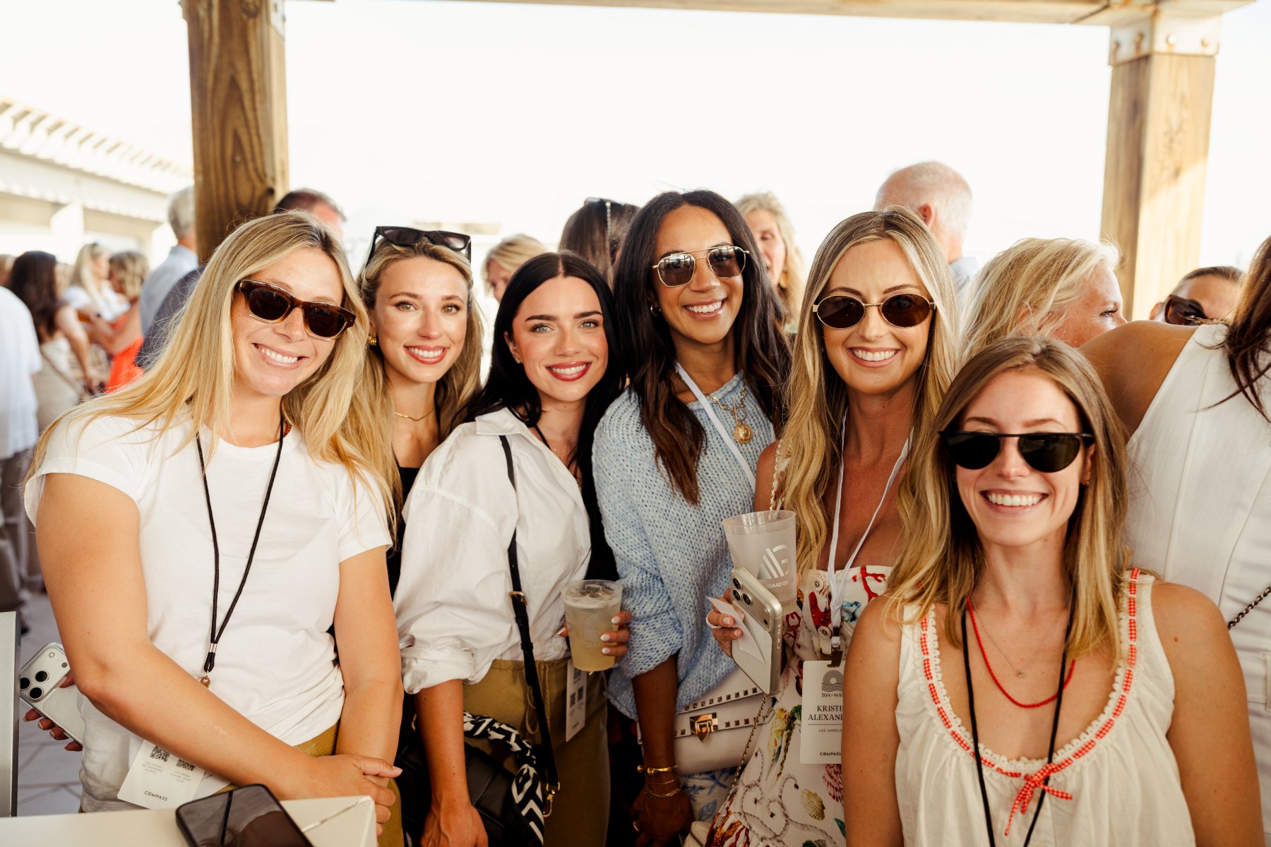 Agents smiling together on a terrace at the kickoff party
